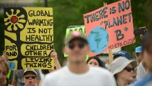 Climate protest takes on Trump's policies -- and the heat -- in DC march