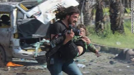 Syria photographer takes action instead of pictures, picks up injured boy