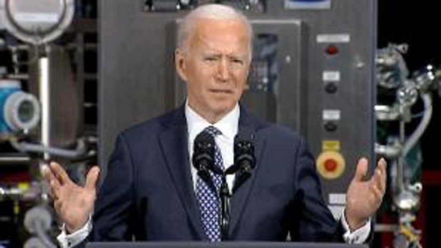 A month into office, Biden seeks to reassure on the pandemic at home and abroad