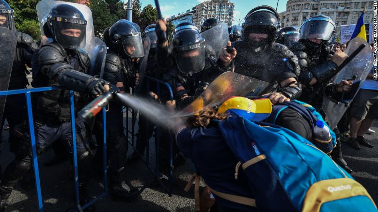 Anti-government protesters and police clash in Romania