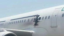 Airport workers seen with laptop used in Somalia in-flight jet blast