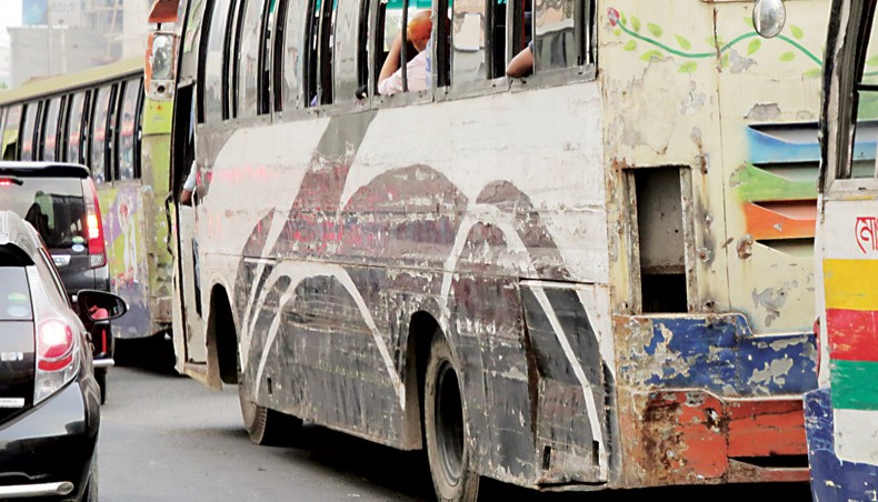 Buses with dented bodies lumber along city roads